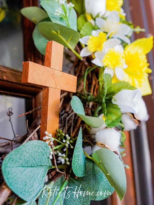 Yellow Flowers and Wooden Cross on a Grapevine Wreath